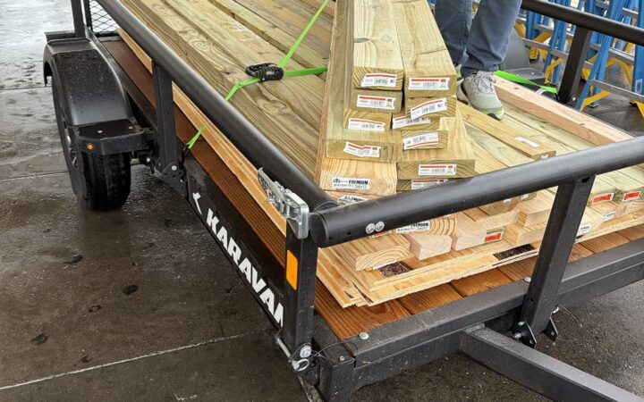 Pressure-treated lumber strapped onto a trailer for building the Center's performance stage